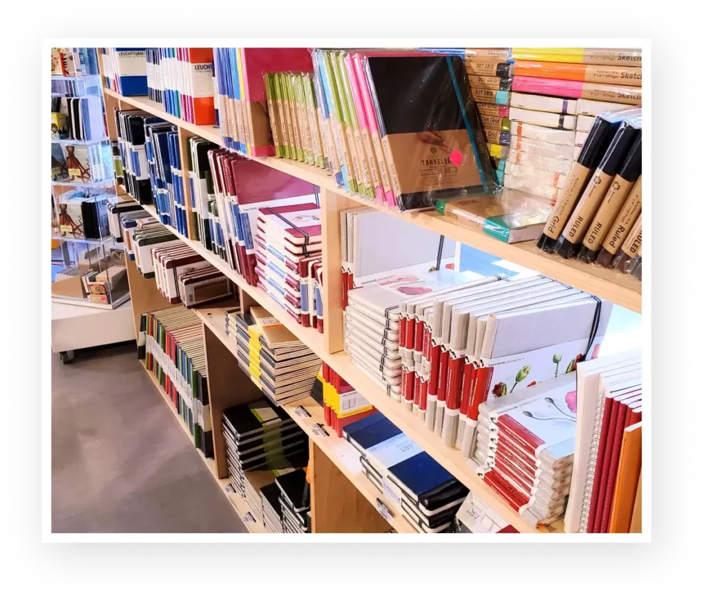 Notepads and art supplies on Shelves in an Arts and Crafts Store.